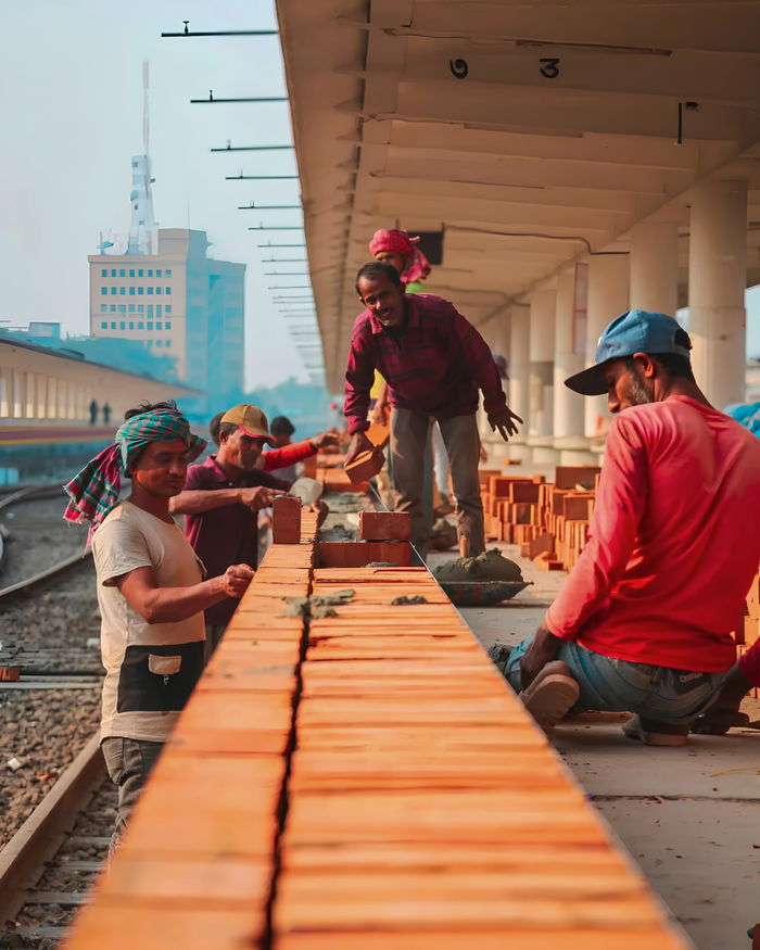 hero-services Workers building a brick wall at a railway platform in Khulna, Bangladesh.